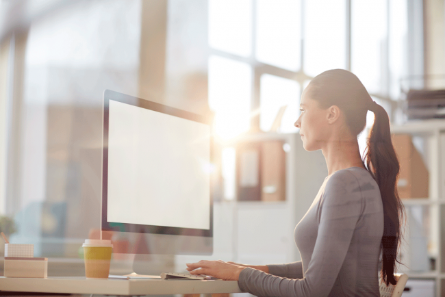 A girl sitting at a computer researching 1031 exchanges