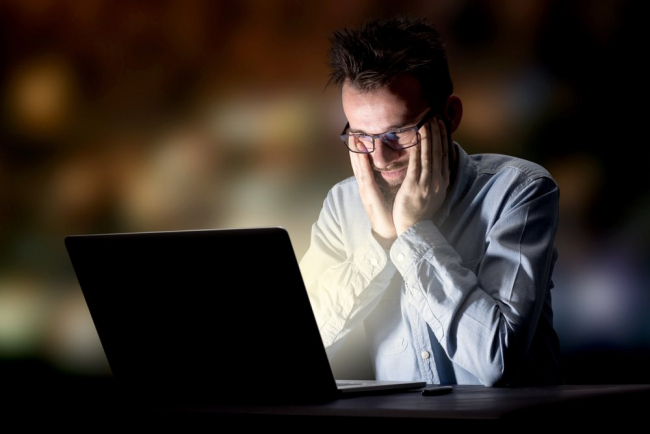 Taxpayer doing research on his laptop and working late