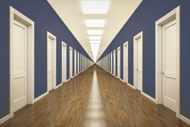 corridor of white doors with blue walls